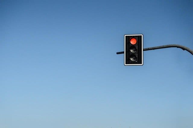 a red-lit traffic light on a blue background